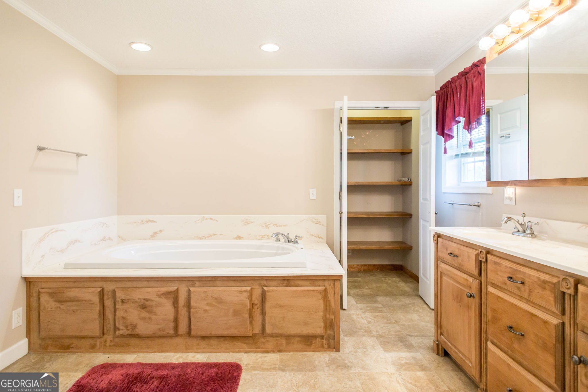 596 Teakwood Road Alma, GA 31510 - Photo 44 of 54 a spacious bathroom with a sink a mirror and a bathtub