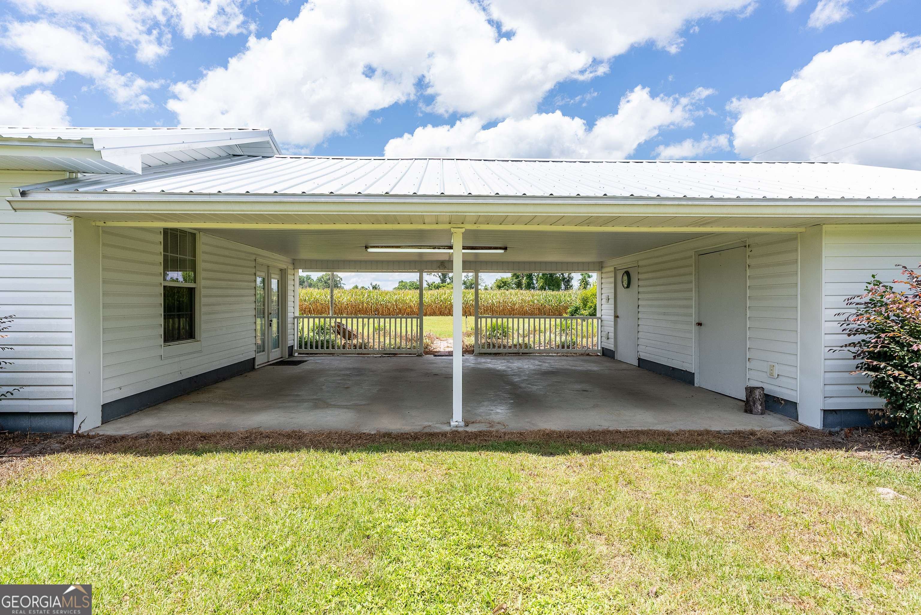 596 Teakwood Road Alma, GA 31510 - Photo 50 of 54 a view of a swimming pool with a lawn chairs under an umbrella