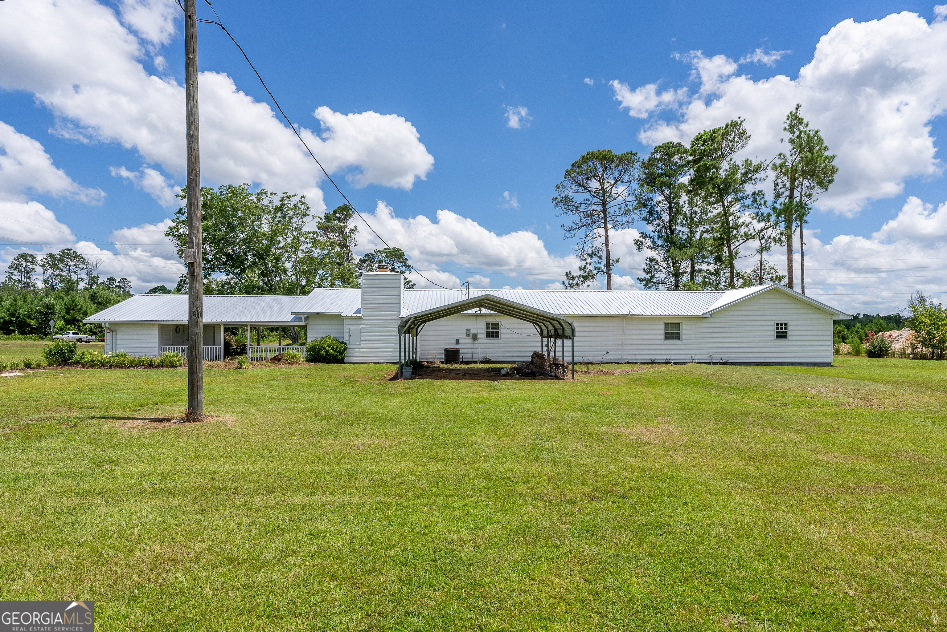 596 Teakwood Road Alma, GA 31510 - Photo 53 of 54 a front view of a house with a yard and garage