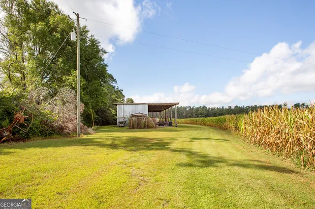 a view of a dining room with furniture a chandelier and wooden floor