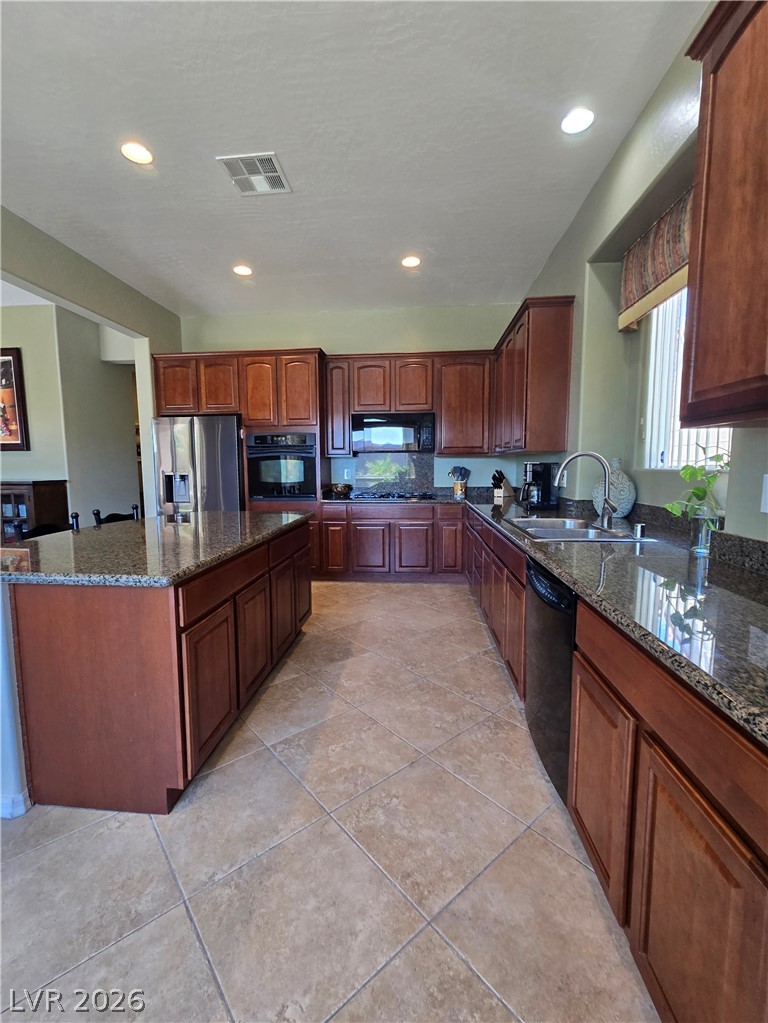 2567 Dirleton Place Henderson, NV 89044 - Photo 16 of 67 A well-appointed kitchen offers ample counter space and rich cabinetry.