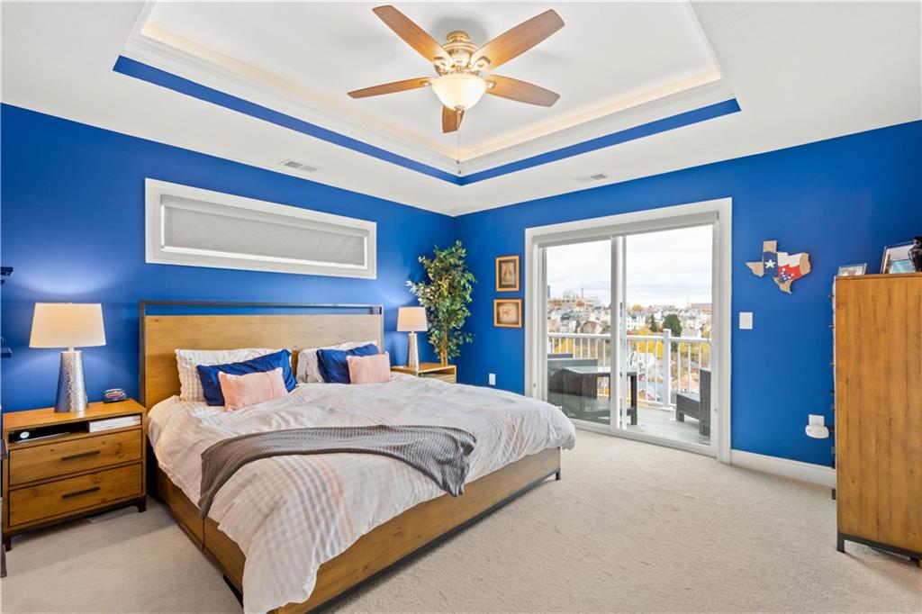 225 Meridan Street Pittsburgh, PA 15211 - Photo 12 of 25 a bedroom with a large bed and a chandelier