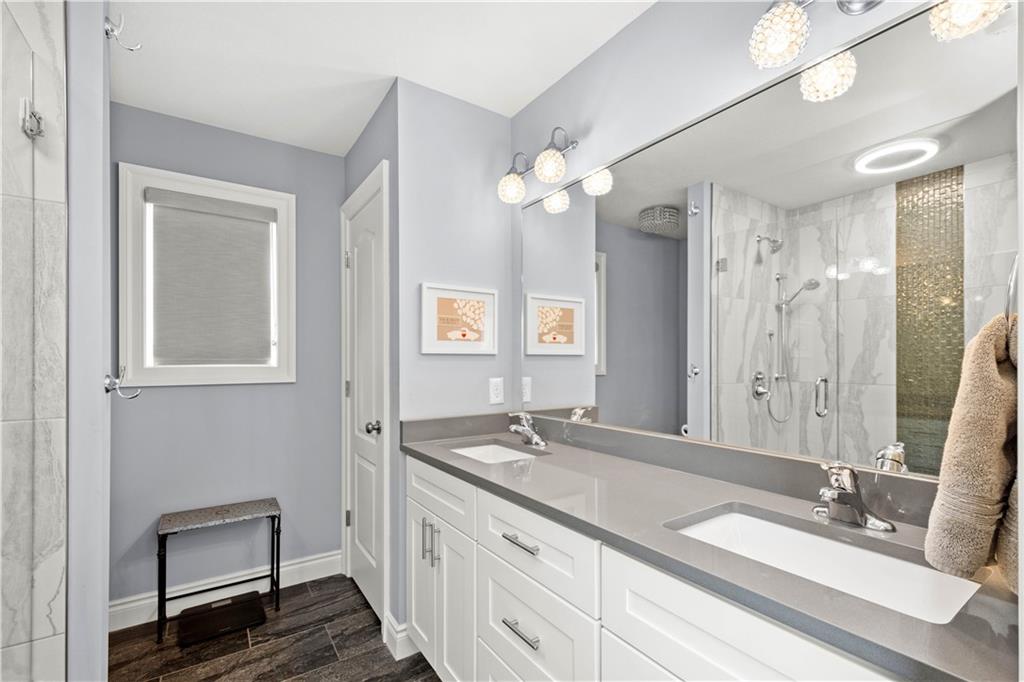 225 Meridan Street Pittsburgh, PA 15211 - Photo 15 of 25 a bathroom with a double vanity sink a mirror and a shower