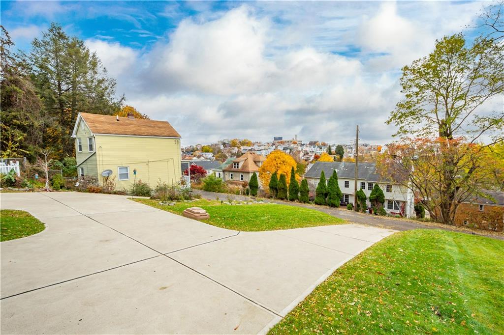 225 Meridan Street Pittsburgh, PA 15211 - Photo 22 of 25 a front view of a house with a yard and trees
