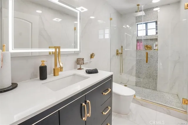 a bathroom with a sink a toilet and shower