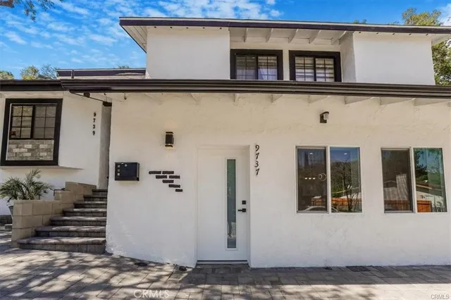 a view of a kitchen with a sink and a refrigerator