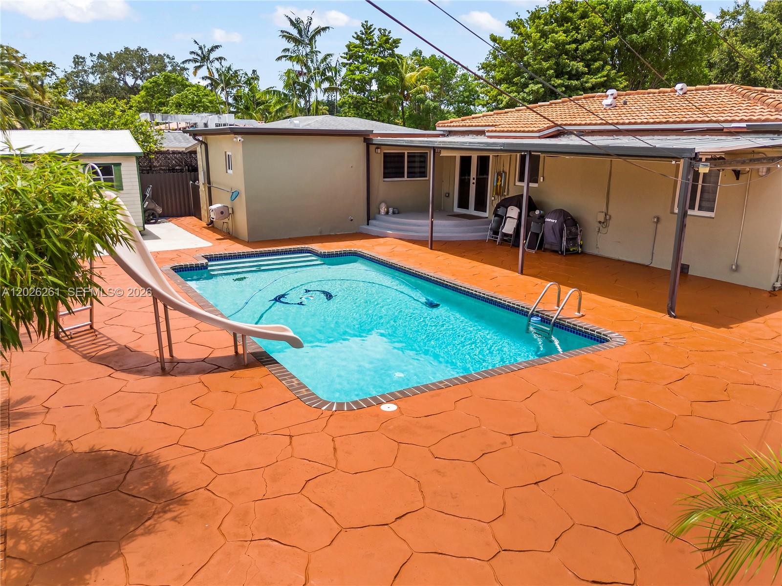 6250 Southwest 20th Terrace Miami, FL 33155 - Photo 33 of 42 a view of a backyard with a patio and wooden fence