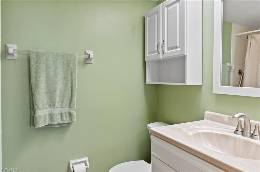 29 High Point Circle East, Unit 508 Naples, FL 34103 - Photo 14 of 35 a bathroom with a sink a toilet and mirror