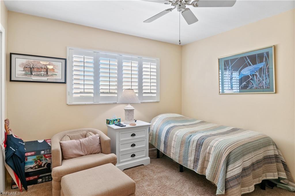 29 High Point Circle East, Unit 508 Naples, FL 34103 - Photo 15 of 35 a bedroom with bed and a couch