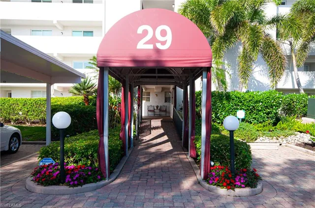 a front view of a house with a garden and shower