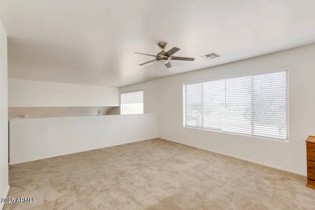 a spacious bathroom with a tub sink and mirror