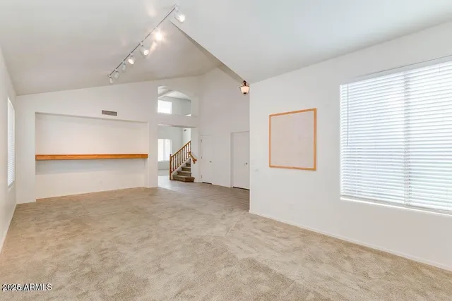 a kitchen with stainless steel appliances granite countertop a sink a oven and a refrigerator