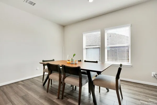 a view of a dining room with furniture and wooden floor