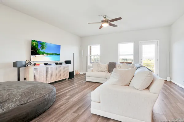 a living room with furniture and flat screen tv