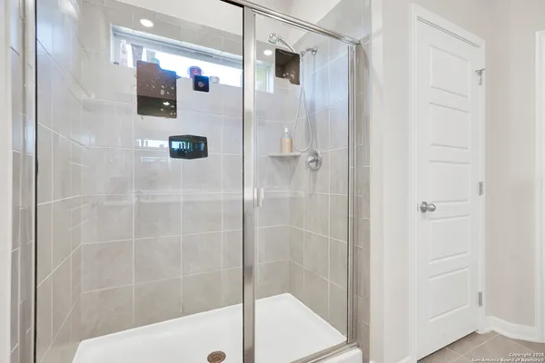 a bathroom with a shower and a sink