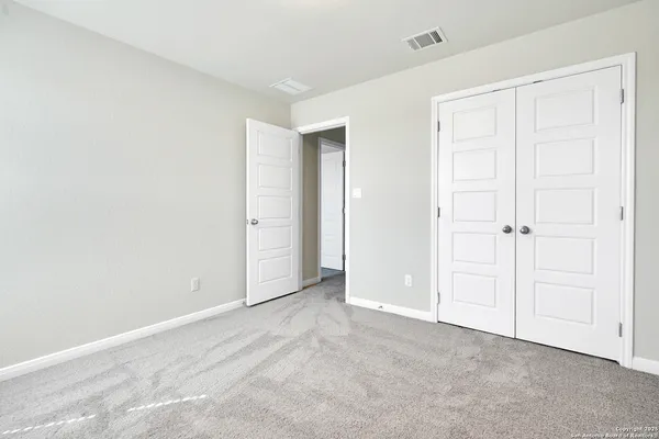 an empty room with closet area