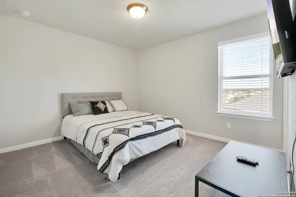 a bed sitting in a bedroom next to a window