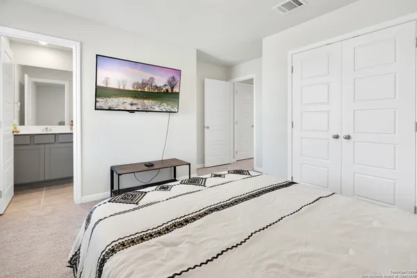 a bedroom with a bed and a painting on the wall