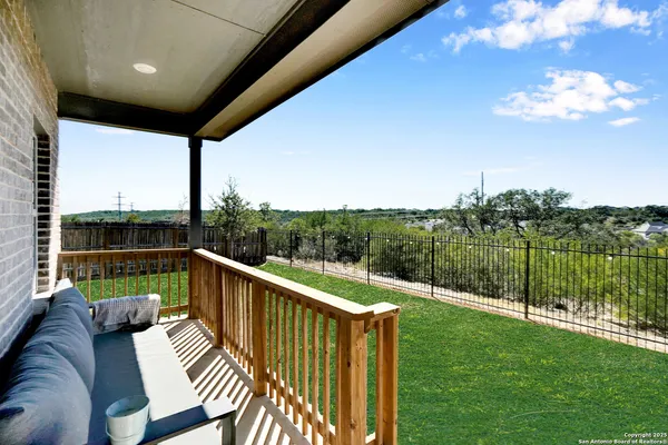 a view of a two chairs in the deck next to a yard