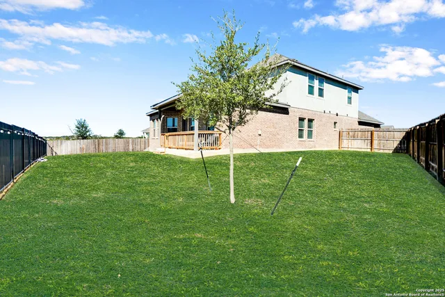 a view of a house with a yard and sitting area