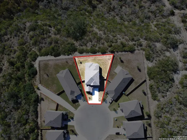 an aerial view of a house with outdoor space