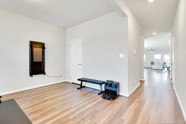 a view of a room with wooden floor and furniture