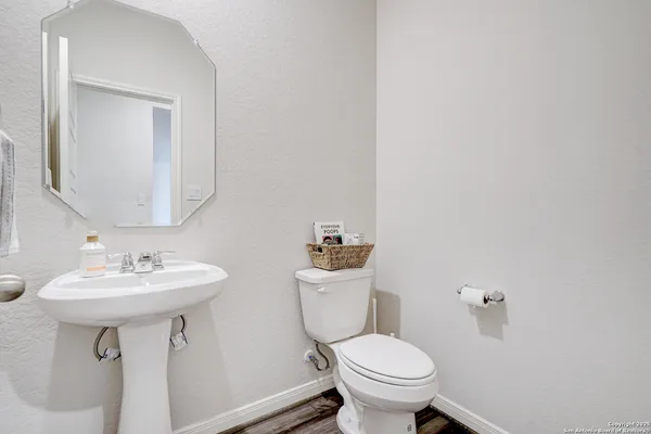 a bathroom with a toilet sink and mirror
