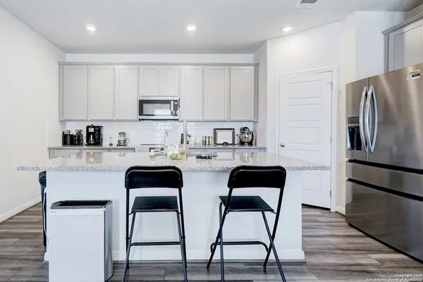 a kitchen with stainless steel appliances a refrigerator stove microwave and cabinets