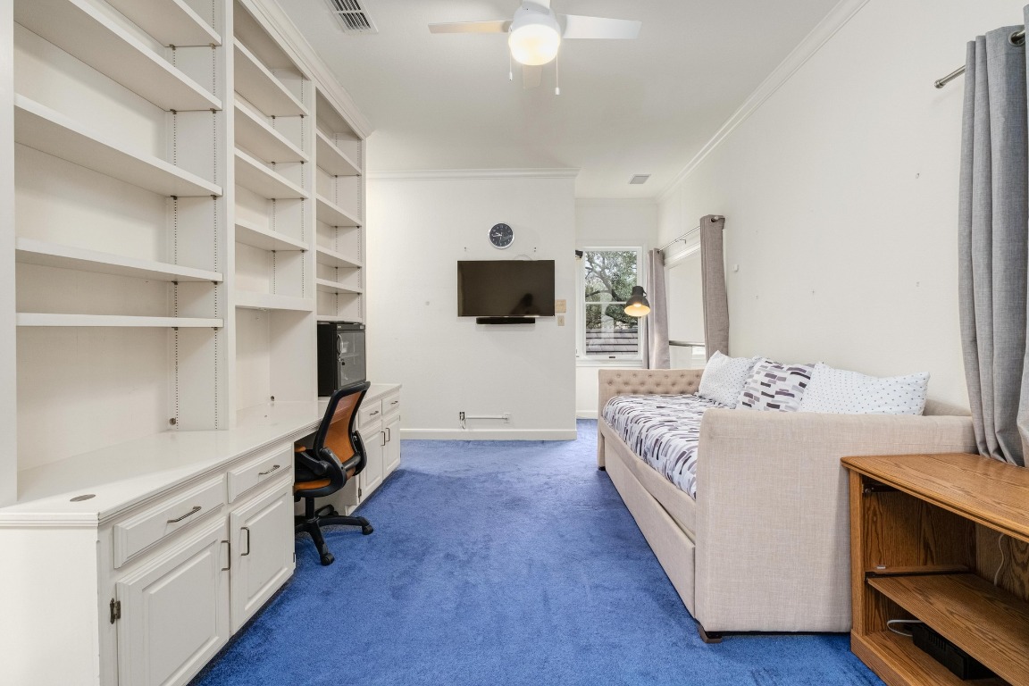 902 West 18th Street, Unit B Austin, TX 78701 - Photo 29 of 39 Loft style bedroom with full bathroom attached and book case shelving/desk