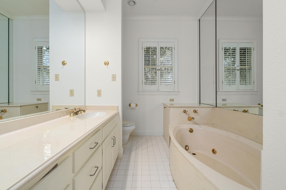 902 West 18th Street, Unit B Austin, TX 78701 - Photo 30 of 39 Full bathroom with a walk in shower, tub with jets, vanity, and light tile floors