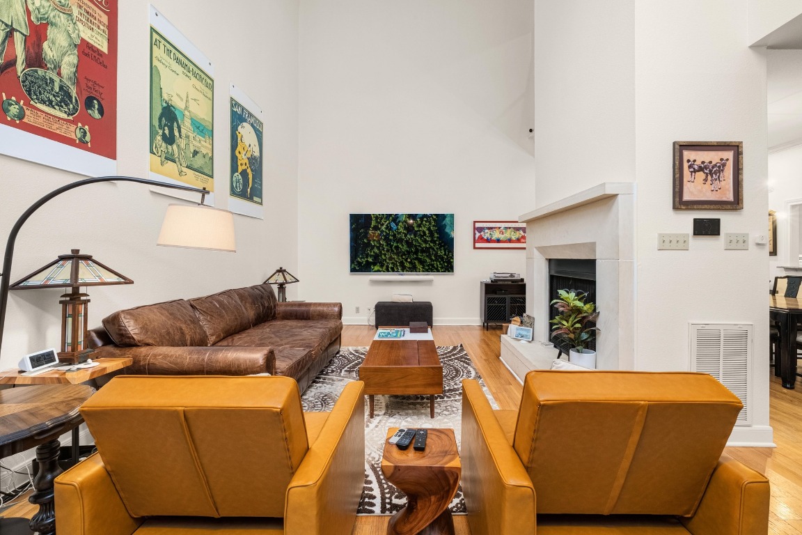 902 West 18th Street, Unit B Austin, TX 78701 - Photo 3 of 39 A great living space for entertaining with a wood burning fireplace as a patrician from the dining area