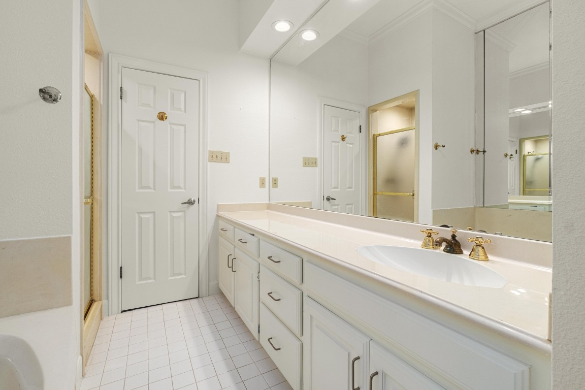 902 West 18th Street, Unit B Austin, TX 78701 - Photo 31 of 39 Full bathroom with a walk in shower, tub with jets, vanity, and light tile floors