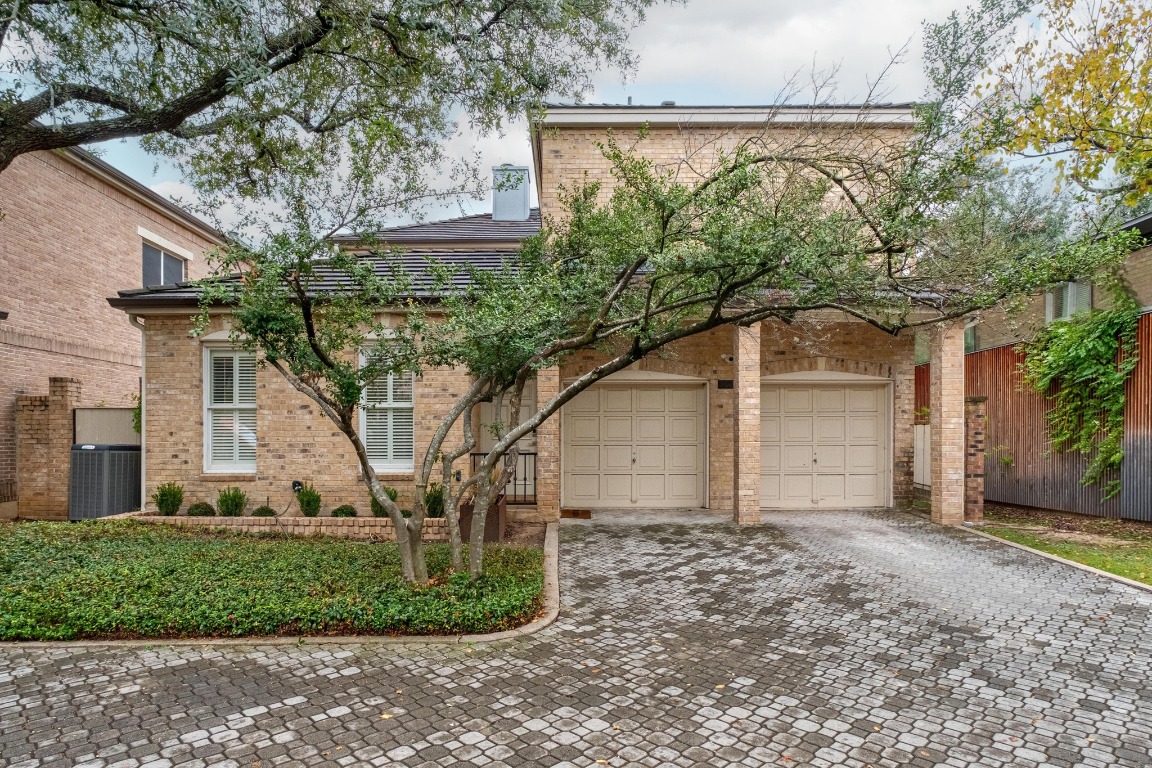 902 West 18th Street, Unit B Austin, TX 78701 - Photo 38 of 39 View of front of house with decorative driveway, brick siding, two car garage