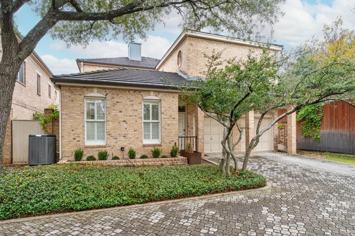 902 West 18th Street, Unit B Austin, TX 78701 - Photo 39 of 39 View of front of house with decorative driveway, brick siding, two car garage