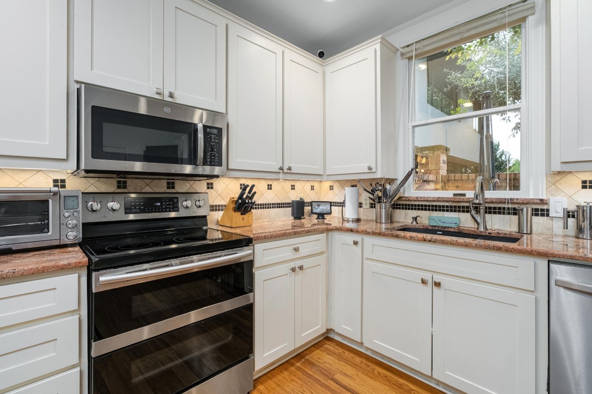 902 West 18th Street, Unit B Austin, TX 78701 - Photo 9 of 39 Kitchen with stainless appliances, granite counters and ample storage