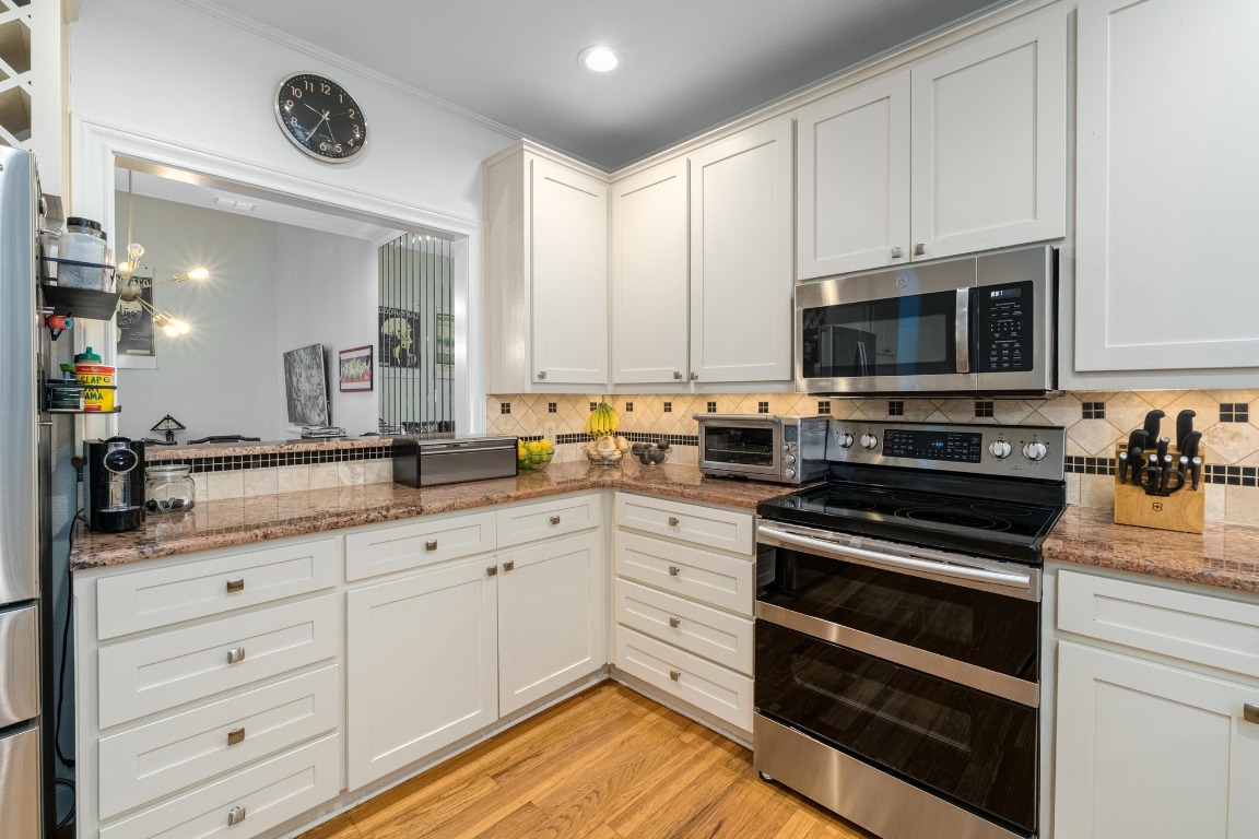 902 West 18th Street, Unit B Austin, TX 78701 - Photo 10 of 39 Kitchen with stainless appliances, granite counters and ample storage