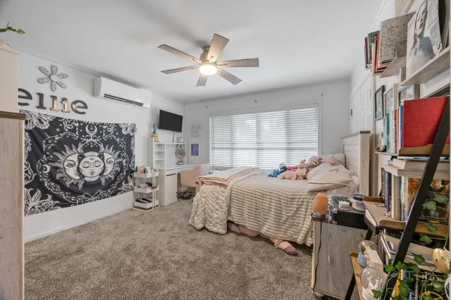 a bedroom with furniture and a large window