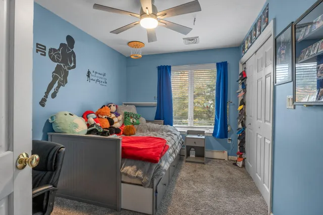 a bedroom with two beds and a chandelier