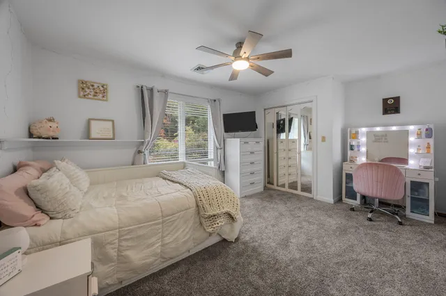 a room with a bed and flat screen tv