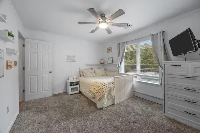 a bed room with a bed and a window