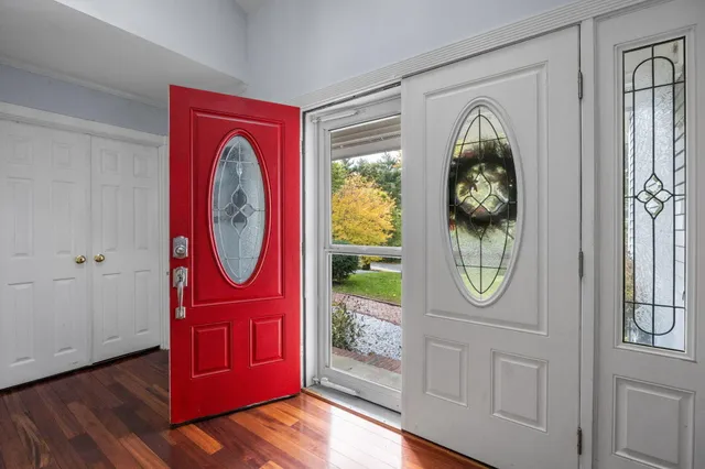 a view of a livingroom with furniture wooden floor and window