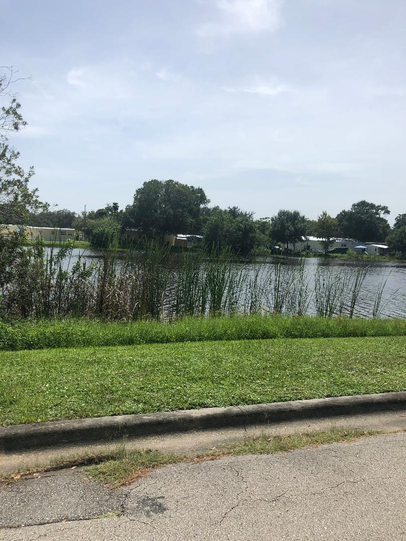 7008 Eden Road Fort Pierce, FL 34951 - Photo 2 of 2 a view of a lake with a big yard