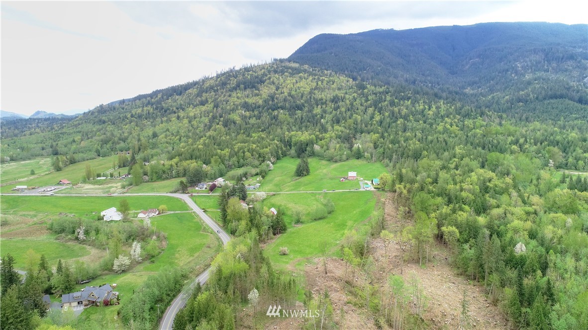 4079 South Pass Road Everson, WA 98247 - Photo 33 of 35 a view of a lush green hillside and a building