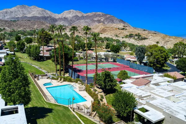 a view of swimming pool with a patio and mountain view