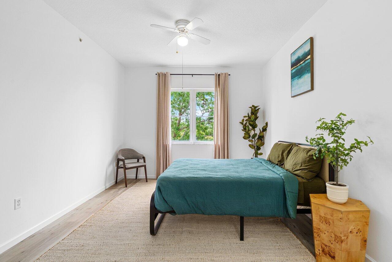 1209 Main Street, Unit 302 Jupiter, FL 33458 - Photo 17 of 35 a bedroom with a bed dresser and a window