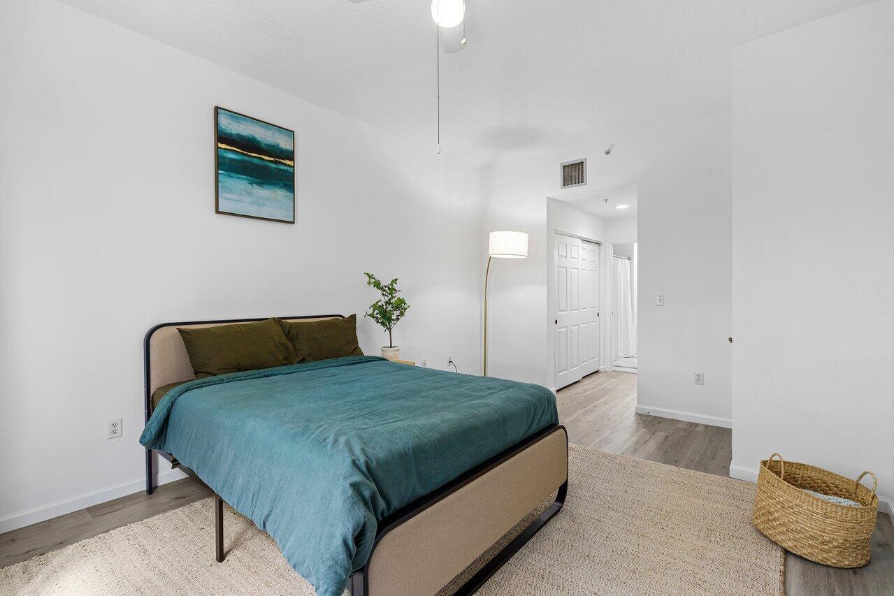 1209 Main Street, Unit 302 Jupiter, FL 33458 - Photo 19 of 35 a bedroom with a bed and a couch