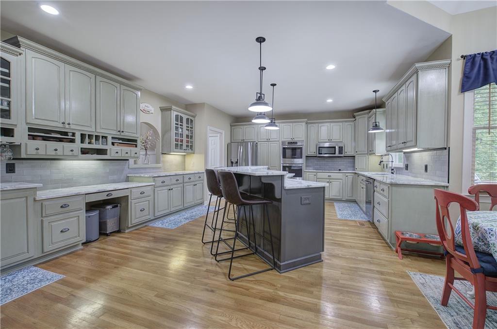 181 Fox Den Circle Jasper, GA 30143 - Photo 6 of 111 a kitchen with stainless steel appliances granite countertop a table chairs sink refrigerator and microwave