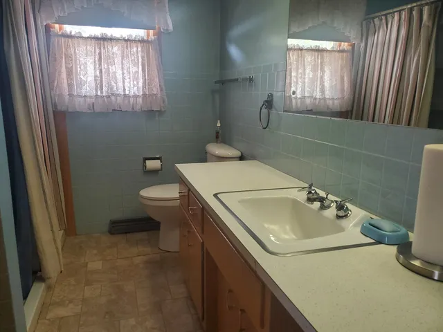 a bathroom with a toilet and a sink
