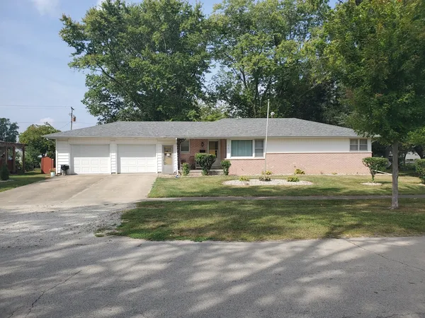 a front view of a house with a yard table and chairs