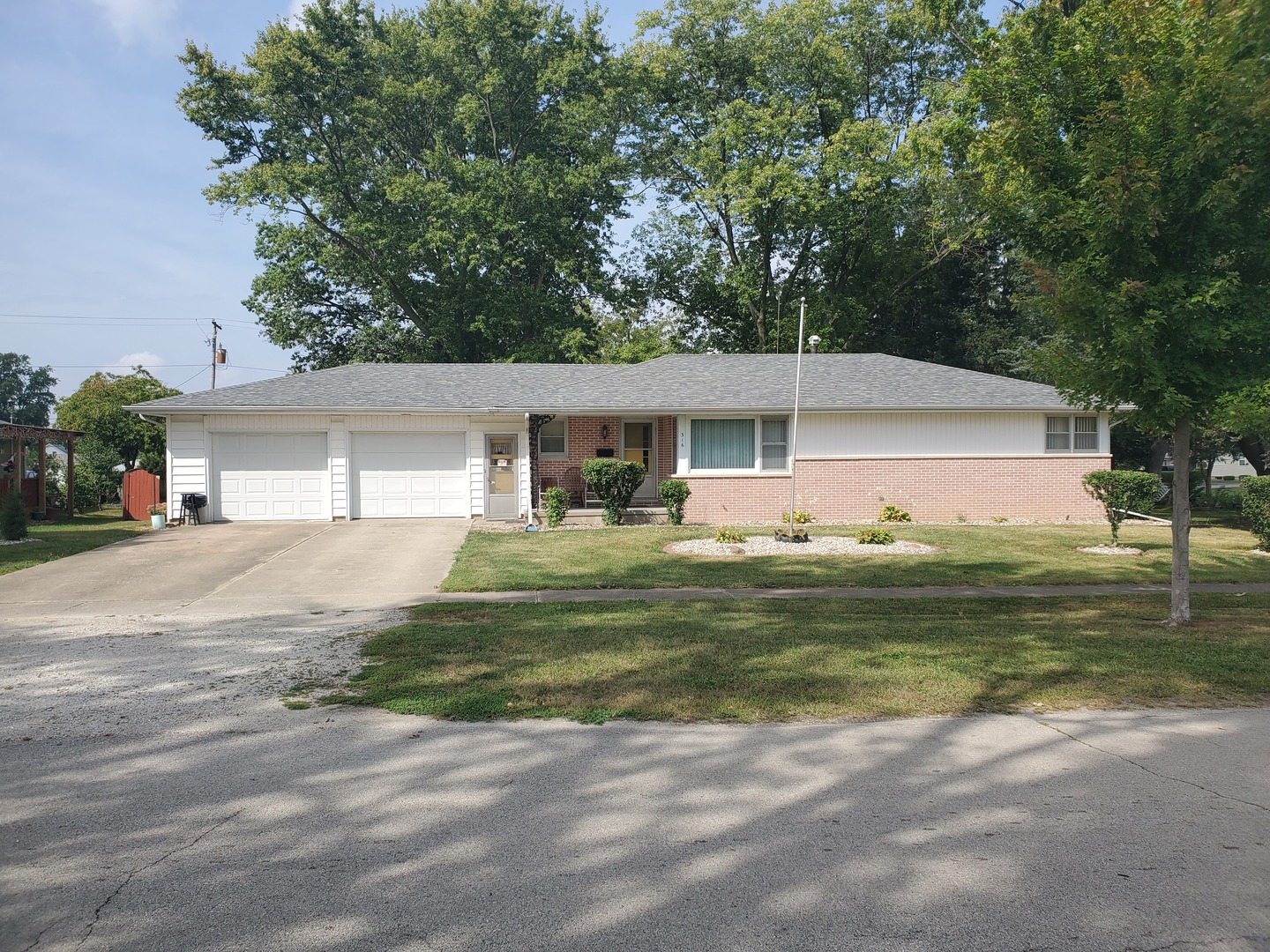 316 North Commerce Street Gilman, IL 60938 - Photo 4 of 26 a front view of a house with a yard table and chairs